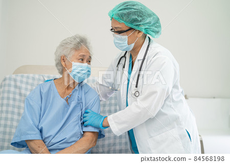 Doctor help Asian senior or elderly old lady woman patient wearing a face mask in hospital for protect safety infection and kill Covid-19 Coronavirus. Doctor help Asian senior or elderly old lady woman patient wearing a face mask in hospital for protect safety infection and kill Covid-19 Coronavirus. 84568198