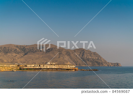 The Republic of Crimea. July 19, 2021. An old abandoned steamer Prince Bagration, standing on a coastal shoal near Cape Meganom in the vicinity of the city of Sudak. The Republic of Crimea. July 19, 2021. An old abandoned steamer Prince Bagration, standing on a coastal shoal near Cape Meganom in the vicinity of the city of Sudak. 84569087