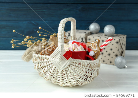 Concept of gift with Christmas basket on white wooden  table 84569771