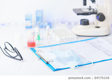 Pandemic COVID-19, Coronavirus. Nobody. Medical supplies, tests, bottles, microscope, clipboard with notes Pandemic COVID-19, Coronavirus. Nobody. Medical supplies, tests, bottles, microscope, clipboard with notes 84570108