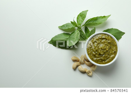 Pesto sauce and ingredients on white background Pesto sauce and ingredients on white background 84570341
