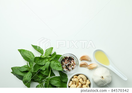 Pesto sauce and ingredients on white background Pesto sauce and ingredients on white background 84570342