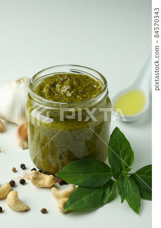 Pesto sauce and ingredients on white background Pesto sauce and ingredients on white background 84570343