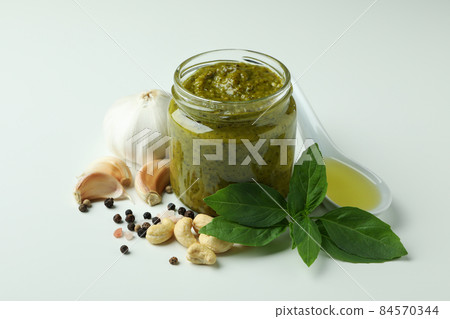 Pesto sauce and ingredients on white background Pesto sauce and ingredients on white background 84570344