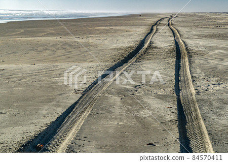 offroad car tracks on pacific ocean sandy beach in Baja California Sur offroad car tracks on pacific ocean sandy beach in Baja California Sur 84570411