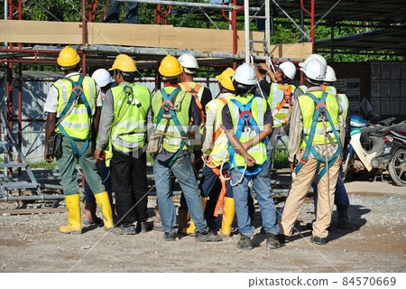 SELANGOR, MALAYSIA -FEBRUARY 13, 2015: Group of construction workers assemble at the open space in the construction site.  84570669