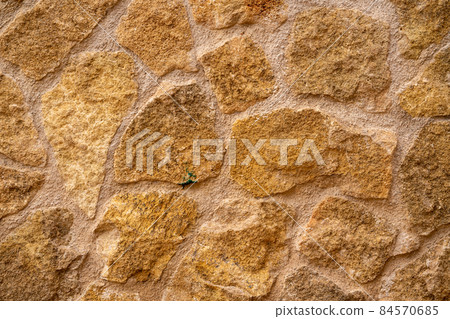 beige rough stone wall texture 84570685