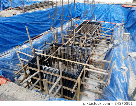 JOHOR, MALAYSIA -JUNE 16, 2015: Pile cap formwork with reinforcement bar in it and the excavated pile at construction site in Johor, Malaysia.  JOHOR, MALAYSIA -JUNE 16, 2015: Pile cap formwork with reinforcement bar in it and the excavated pile at construction site in Johor, Malaysia.  84570891