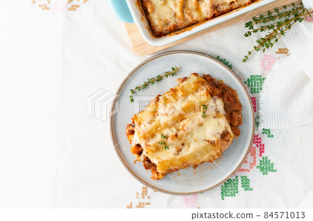 Cannelloni pasta with filling of ground beef, tomatoes, baked with bechamel 84571013