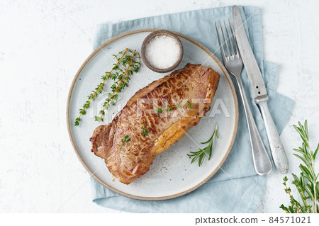 Keto ketogenic diet beef steak, striploin on gray plate on white background. 84571021