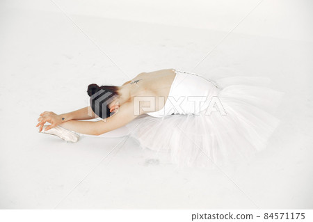Ballerina posing in front of white background Ballerina posing in front of white background 84571175