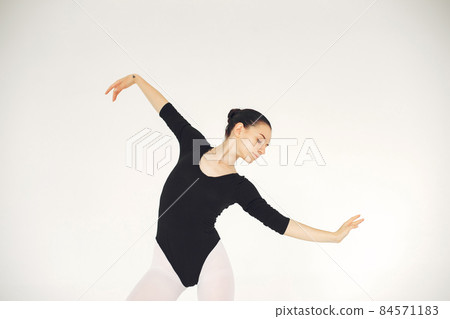 Ballerina posing in front of white background Ballerina posing in front of white background 84571183