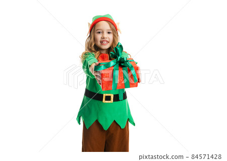 Portrait of happy little girl dressed like funny gnome or elf holding red gift box isolated over white studio background. 84571428