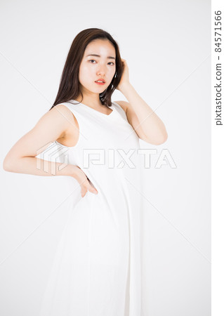 A woman in a white dress A woman in a white dress 84571566