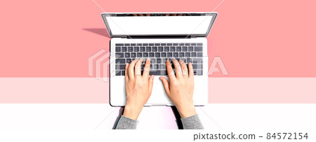Person using a laptop computer Person using a laptop computer 84572154