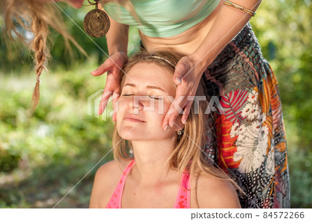 Massage girl gives her client a refreshing massage in the outdoors. 84572266