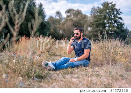 Brutal vaper blowing a lot of smoke using vape electronic cigarette. Electronic cigarette. Brutal vaper blowing a lot of smoke using vape electronic cigarette. Electronic cigarette. 84572336