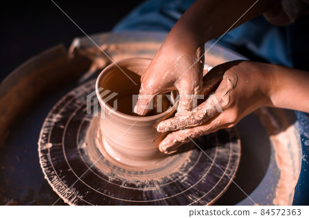 Pottery girl sculpts from clay. Handmade products. Close-up. Pottery girl sculpts from clay. Handmade products. Close-up. 84572363