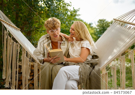Love couple relaxing on hammock, summer camping Love couple relaxing on hammock, summer camping 84573067
