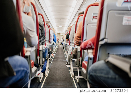 passage between seats in the cabin of the aircraft. flying during the pandemic. passage between seats in the cabin of the aircraft. flying during the pandemic. 84573294