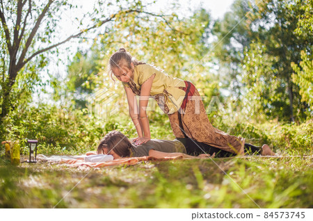 Master massage therapist impliments her massage abilities on the forest ground. Master massage therapist impliments her massage abilities on the forest ground. 84573745
