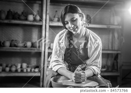 Processing clay ware and making dishes, process. Ceramics of handwork and clay ware on the potter's wheel. Processing clay ware and making dishes, process. Ceramics of handwork and clay ware on the potter's wheel. 84573766