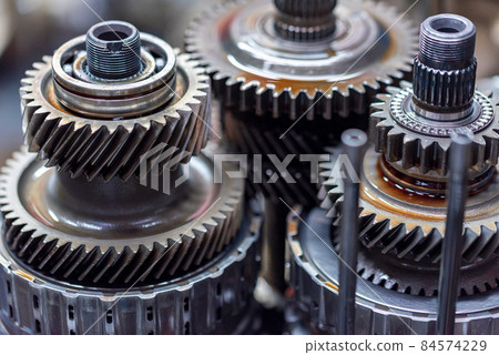Close-up helical gears in car automatic transmission 84574229