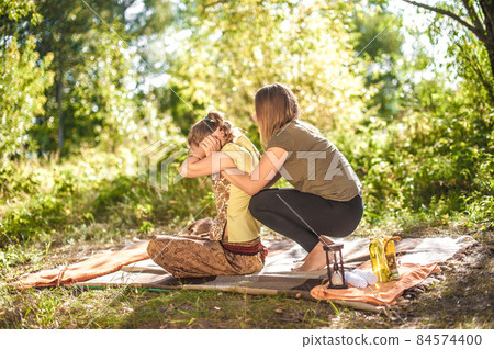 Girl masseuse demonstrates refreshing massaging methods outside. 84574400