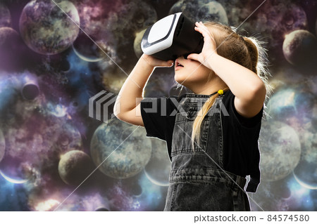 Cute teenage girl using VR glasses on colorful background with blank space for text 84574580