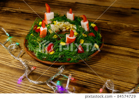 Salad Christmas wreath on a wooden table Salad Christmas wreath on a wooden table 84574729