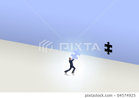 Businessman putting missing jigsaw puzzle piece 84574925