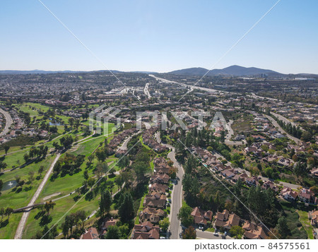 Aerial view of golf in residential neighborhood in an Diego County 84575561