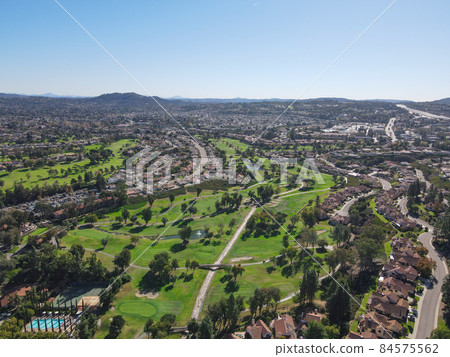 Aerial view of golf in residential neighborhood in an Diego County Aerial view of golf in residential neighborhood in an Diego County 84575562