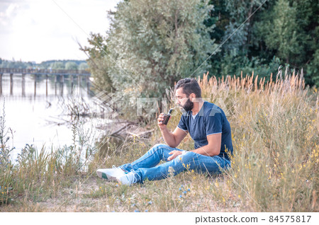 Confident smoker enjoying electronic smoke device. Getting rid of nicotine addiction. Confident smoker enjoying electronic smoke device. Getting rid of nicotine addiction. 84575817