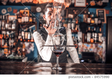 Barman makes a cocktail in the pothouse Barman makes a cocktail in the pothouse 84575990