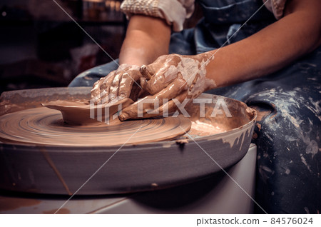 Craftsmen sculpts from clay. Craft manufacture. Close-up. Craftsmen sculpts from clay. Craft manufacture. Close-up. 84576024