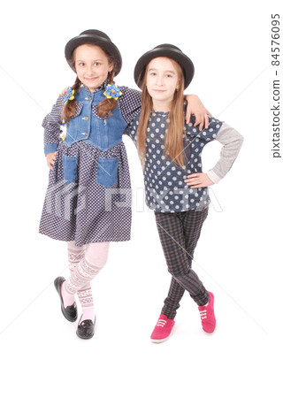 Portrait two smiling little girl 84576095