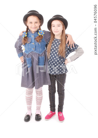 Portrait two smiling little girl 84576096