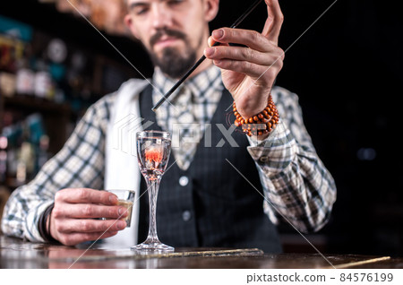 Bartender concocts a cocktail at the saloon Bartender concocts a cocktail at the saloon 84576199