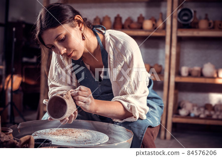 Charming ceramist sculpts from clay. Artisan production. 84576206