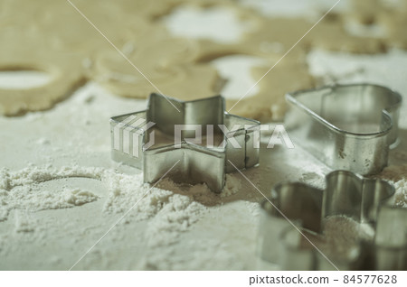 Cookie molds, with rolled dough and flour on the table. Selective focus Cookie molds, with rolled dough and flour on the table. Selective focus 84577628