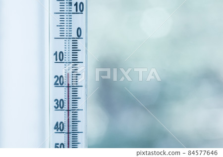 Outdoor thermometer in degrees Celsius close-up. Sub-zero temperature on the thermometer. Winter. 84577646