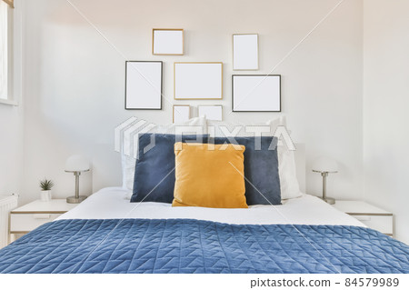 Luxurious bedroom with soft bed and blue bedspread 84579989