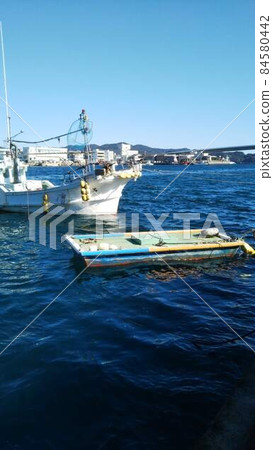 A fishing boat was floating in the blue sea A fishing boat was floating in the blue sea 84580442