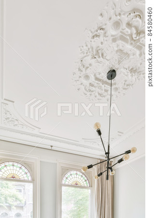Graceful ceiling with a pattern and a chandelier in the middle 84580460
