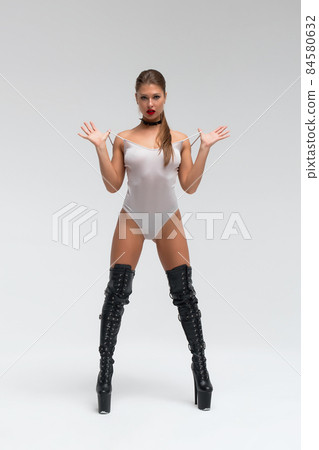 Sexy young woman in bodysuit and boots 84580632