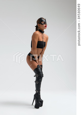 Seductive brunette in BDSM costume 84580649