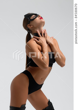 Seductive brunette in BDSM costume 84580670