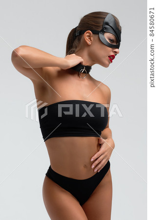Seductive brunette in BDSM costume 84580671