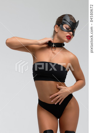 Seductive brunette in BDSM costume 84580672